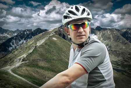 Men with bicycle aroun mountains beautiful view.の写真素材