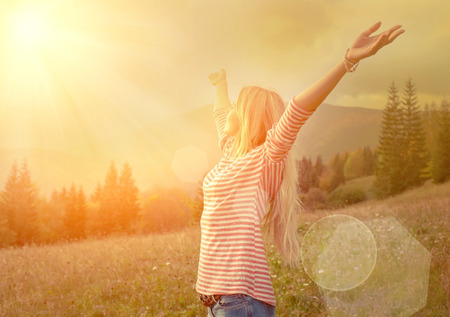 Happiness woman stay outdoor under sunlight of sunset