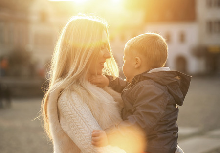 Happiness mother and son on the street at sunny day.の写真素材