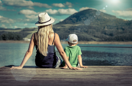 Happiness mother and son on the pier at sunny day under sunlight.の写真素材