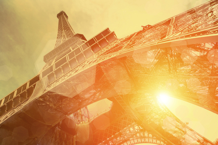 The Eiffel tower is one of the most recognizable landmarks in the world under sun lightの写真素材