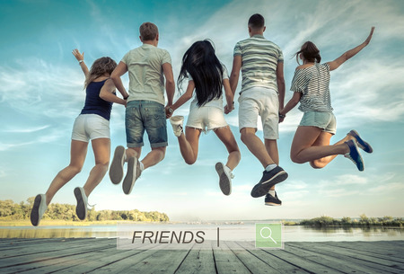 Group of friends jumping on the pier under sunlight.の写真素材