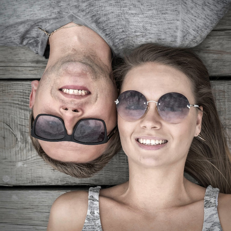 Portrait of couple on the wooden background.