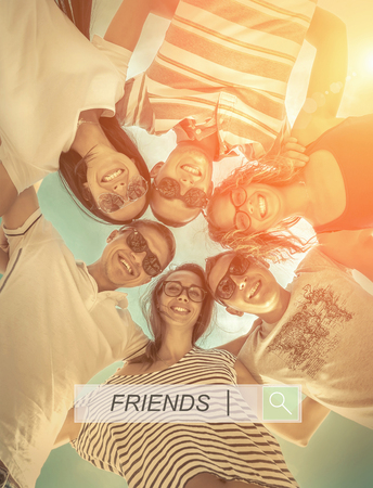 Group of friends on the beach under sunlight.の写真素材