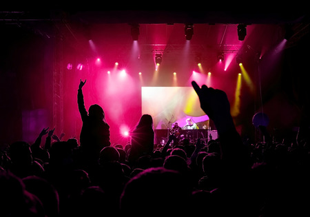 Rock concert, silhouettes of happy people raising up handsのeditorial素材