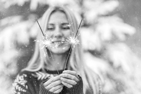 woman with sparkler at winter.の写真素材