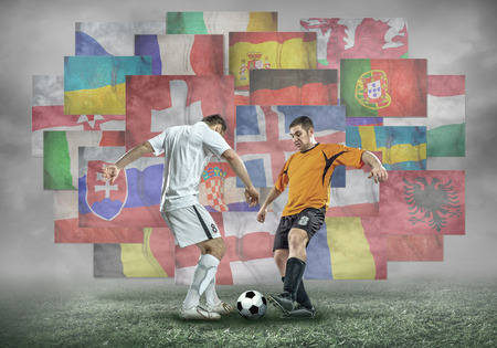 Football player with ball in action under sky with cloudsの写真素材