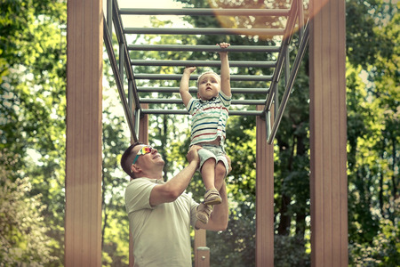 Father and son exercising outdoor.の写真素材