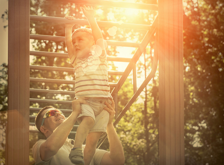 Father and son exercising outdoor.