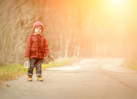 Beautiful boy stay on the road in forestの写真素材