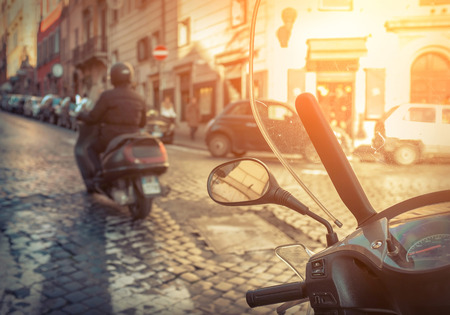 Old car and retro scooters in Rome. Scooters are the symbol of Rome - most popular historical travel place of the Italy and the world.の写真素材