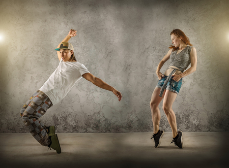 Hip Hop dancer in dynamic action jump on the grunge grey background.の写真素材