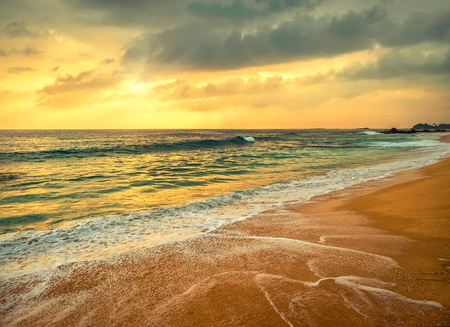 Beautiful Tropical Sea view under sunset sky at Sri Lankain beach. Stormy waves in evening time.の写真素材