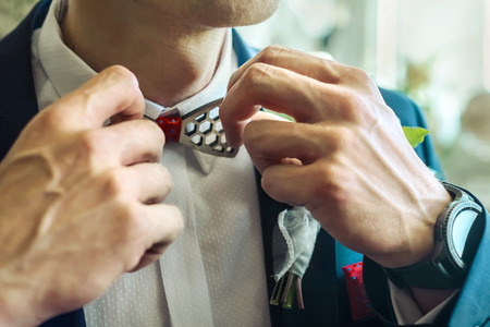 Wedding white flowers on the blue mans jacket with red accessory.の写真素材