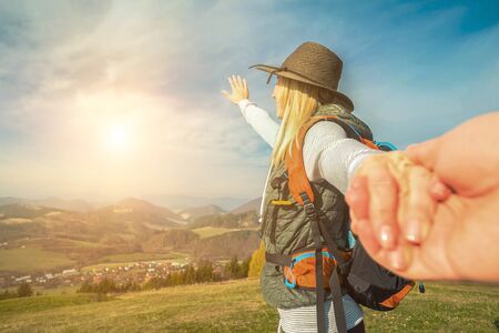 Happy traveler woman tourist stay on the green grass on the peak of mountain and look on the nice fog view. Concept follow me freedom.の写真素材