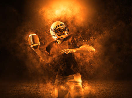 American football sportsman player with ball in action on stadium under lights of background. Sport, proud footballer in white helmet and red t-shirt ready to play.