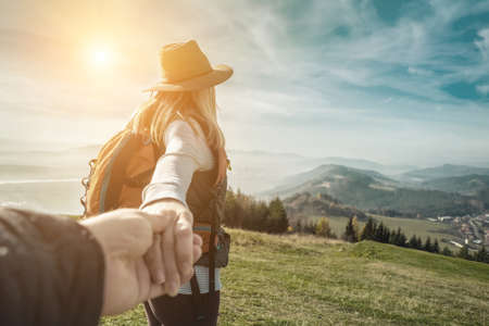 Happy traveler woman tourist stay on the green grass on the peak of mountain and look on the nice fog view. Concept follow me freedom.の写真素材