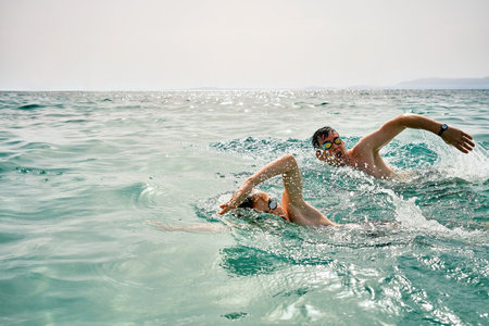 Happy family in swimming goggles, father and son bonding, swim in the sea looking at view enjoying summer vacation. Togetherness Friendly conceptの写真素材