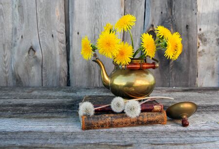 Bouquet of dandelions in a copper jug.の写真素材
