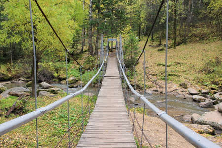 Suspension bridge over the Belokurikha river in the resort area of ââthe city of Belokurikha. Altai region. Russia.の写真素材