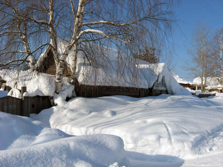 An old house in a Siberian village in the Krasnoyarsk Territory. The beauty of the Russian Siberian winter.の写真素材