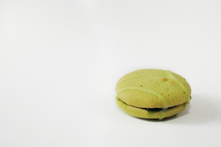 One macaroon on white cutout. Green french sweet with cream.の写真素材