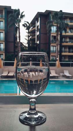 Glass of water near the pool in the hotelの写真素材