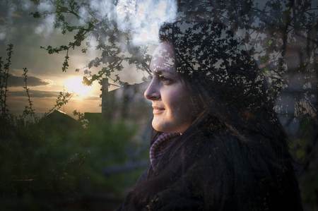 Multi exposure of girl and nature. Girl looking at the sun