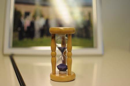 Sand clock on the table. Time is running