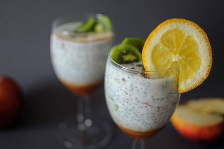 Healthy chia pudding in a glass with fresh fruits and honeyの写真素材
