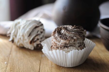 Homemade marshmallow zephyr with cup of coffee and cezve on the bed in the morning