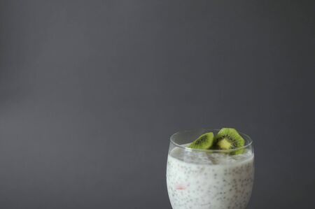 Healthy chia pudding in a glass with fresh kiwi and strawberries jamの写真素材
