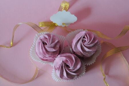 Group of homemade marshmallow berry zephyr on pink background with gift note