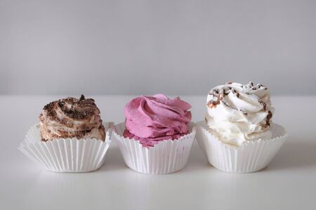 Homemade marshmallow berry zephyr on white background in paper basketの写真素材