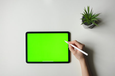 Person drawing on touch pad. Minimal interior.Remote freelance work.Green screen