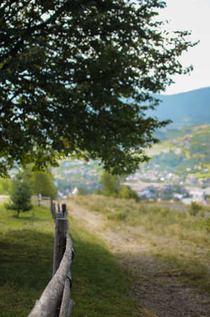Path in mountains with a wooden fence without people. Summer timeの写真素材