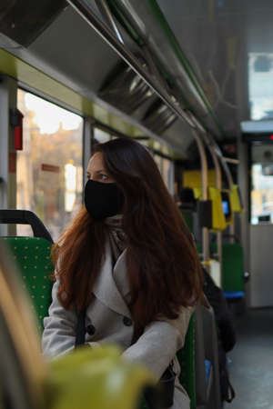 Multi-age caucasian people in face masks protection drive in a bus.の写真素材