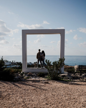 A young couple is standing inside a sculpture square in the Sculpture Park in Ayia Napa national...