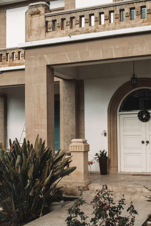 Modern building with columns, balcony and tropical plants in Larnaca, Cyprus