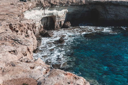 Beautiful sea caves near cape Greco in national park with turquoise waterの写真素材