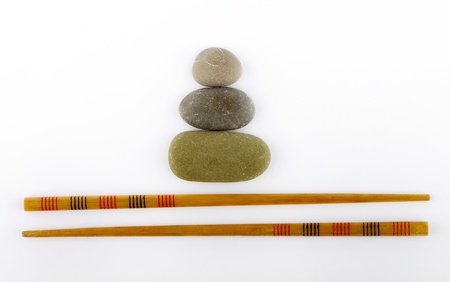 chopsticks and stones isolated on white backgroundの写真素材