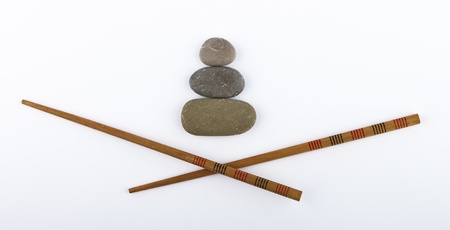 chopsticks and stones isolated on white backgroundの写真素材