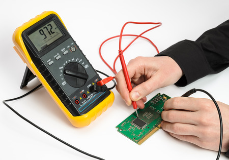 Testing electronic device. Measuring by multimeter