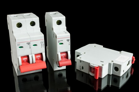 Various automatic circuit breakers, isolated on black background. Electric fuse.の写真素材