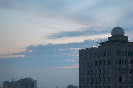 On the background of the observatory building crescent moon in the skyの写真素材