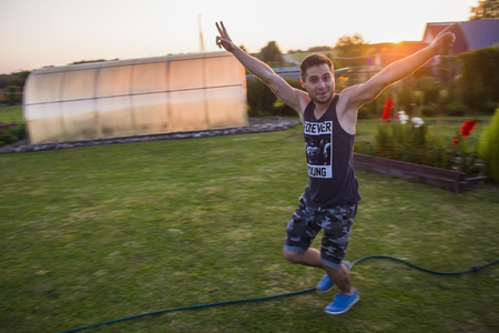 lucky guy runs across the grass toward the open hands