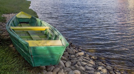 the boat lies on the shore of the riverの写真素材