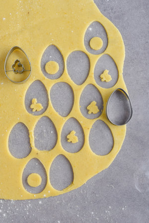 Making the Easter cookies in form of eggs and rabbits
