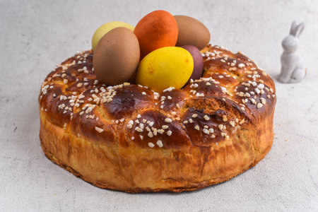Easter brioche with cream and natural painted eggs