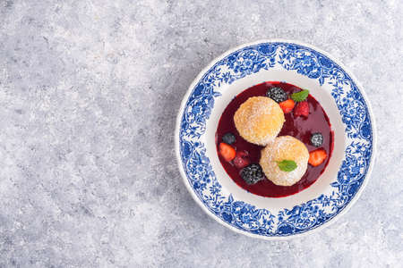 Sweet dumplings with berry sauce and fresh berries